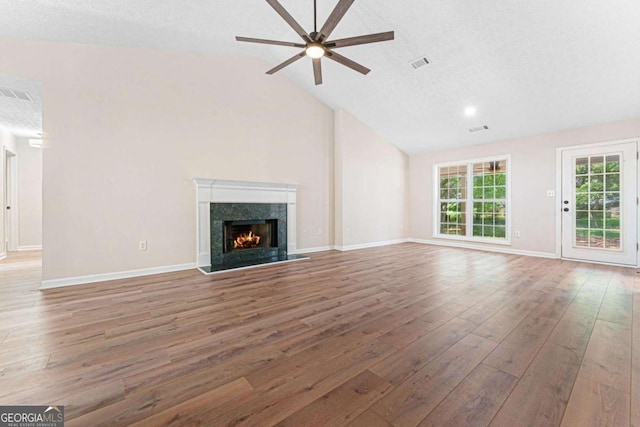 4210 Platinum Ct, Hoschton, GA 30548 - unfurnished living room featuring a ceiling fan, wood finished floors, a premium fireplace, high vaulted ceiling, and a textured ceiling