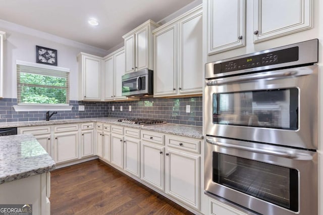 2307 Loughridge Dr, Buford, GA 30519 - kitchen with stainless steel appliances, tasteful backsplash, white cabinets, light stone counters, and recessed lighting