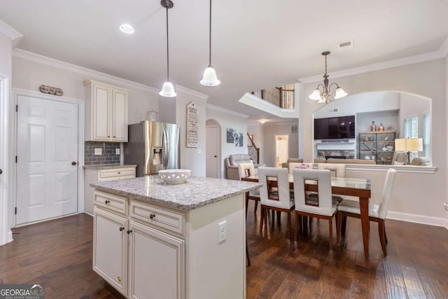 2307 Loughridge Dr, Buford, GA 30519 - kitchen featuring stainless steel refrigerator with ice dispenser, arched walkways, crown molding, a chandelier, and dark wood finished floors