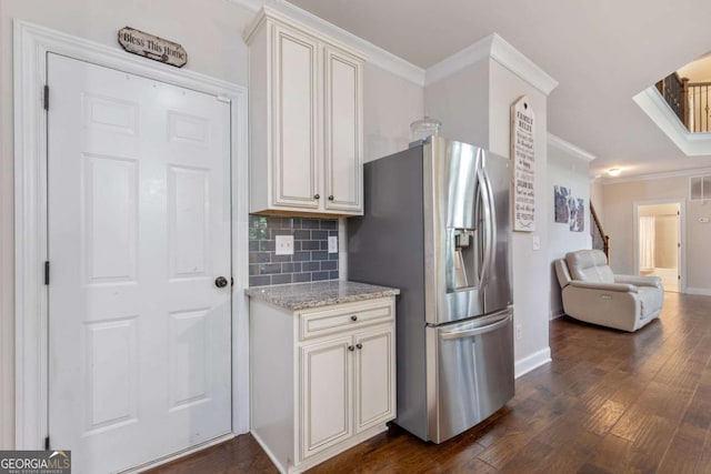 2307 Loughridge Dr, Buford, GA 30519 - kitchen featuring stainless steel fridge with ice dispenser, ornamental molding, dark wood-type flooring, decorative backsplash, and light stone counters