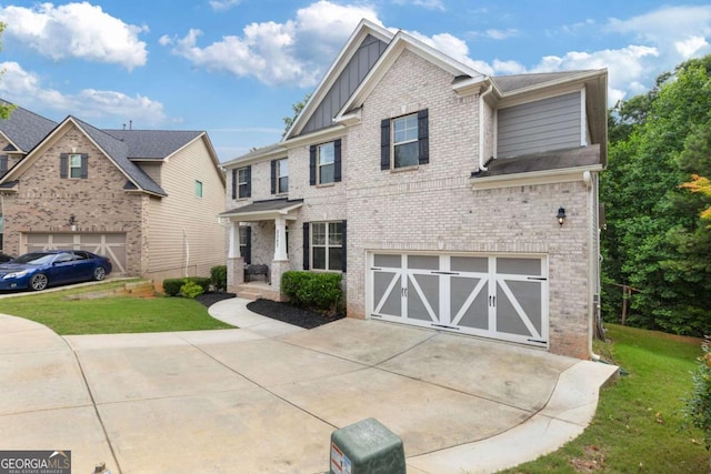 2307 Loughridge Dr, Buford, GA 30519 - craftsman-style home with board and batten siding, a garage, driveway, and a front yard