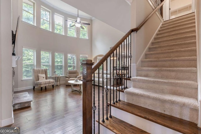 2307 Loughridge Dr, Buford, GA 30519 - staircase featuring ceiling fan, a high ceiling, wood finished floors, and ornamental molding