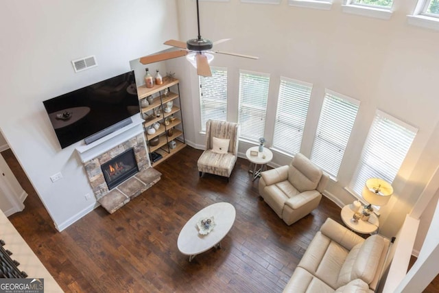 2307 Loughridge Dr, Buford, GA 30519 - living room featuring wood-type flooring, a ceiling fan, a fireplace, and a towering ceiling