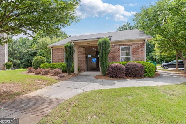 2307 Loughridge Dr, Buford, GA 30519 - view of front facade featuring a front yard and brick siding
