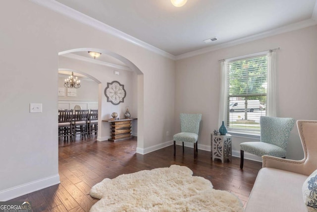 2307 Loughridge Dr, Buford, GA 30519 - living area featuring arched walkways, crown molding, hardwood / wood-style flooring, and a chandelier