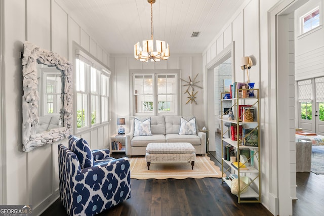 31 Frederica Oaks Ln, Saint Simons, GA 31522 - living area with a chandelier, wood finished floors, wood ceiling, and a decorative wall