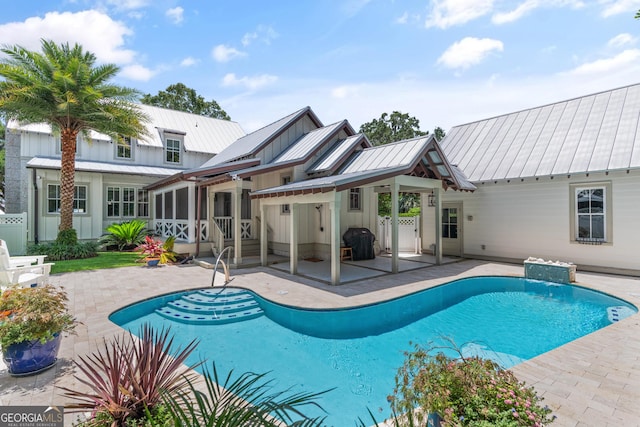 31 Frederica Oaks Ln, Saint Simons, GA 31522 - swimming pool featuring a patio and a sunroom