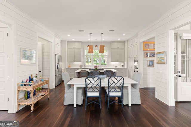 31 Frederica Oaks Ln, Saint Simons, GA 31522 - dining space with dark wood finished floors, wood walls, and recessed lighting