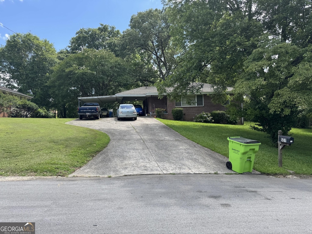 537 Elizabeth Ln SW, Mableton, GA 30126 - ranch-style home featuring concrete driveway, a carport, a front yard, and brick siding