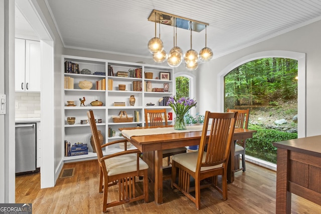 970 Pine Grove Pointe Dr, Roswell, GA 30075 - dining space with ornamental molding, a chandelier, and light wood finished floors