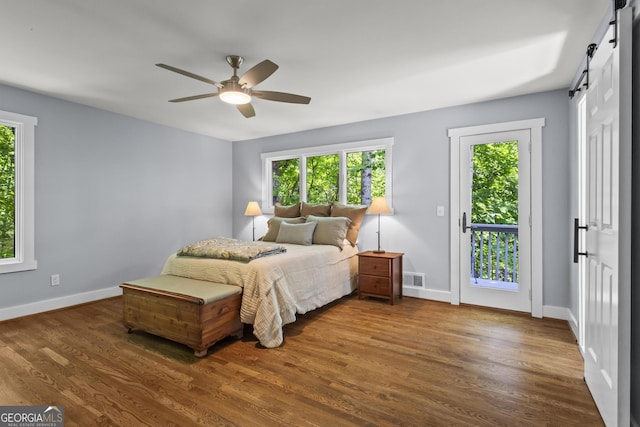 970 Pine Grove Pointe Dr, Roswell, GA 30075 - bedroom featuring a barn door, access to exterior, wood finished floors, and ceiling fan