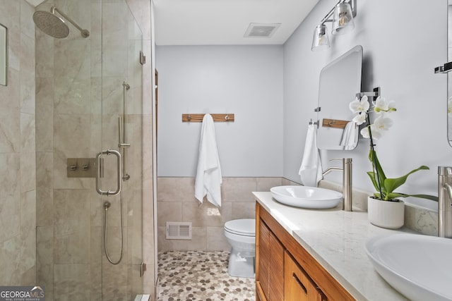 970 Pine Grove Pointe Dr, Roswell, GA 30075 - bathroom featuring a stall shower, double vanity, tile patterned floors, tile walls, and wainscoting