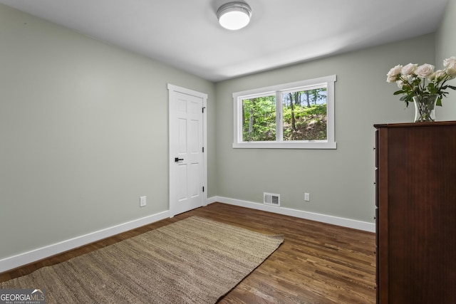 970 Pine Grove Pointe Dr, Roswell, GA 30075 - unfurnished bedroom featuring baseboards and wood finished floors