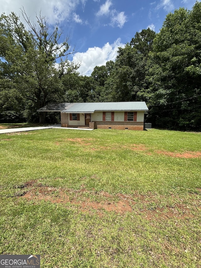 307 Hickman Rd, Forsyth, GA 31029 - single story home with a front lawn and a metal roof