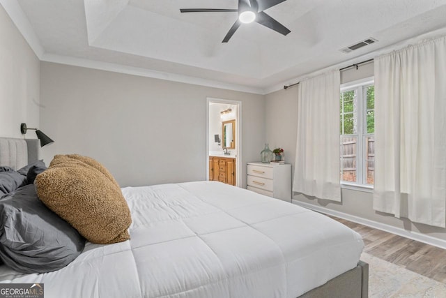 15 Stonewood Way, Sharpsburg, GA 30277 - bedroom featuring wood finished floors, a raised ceiling, ceiling fan, and ensuite bathroom