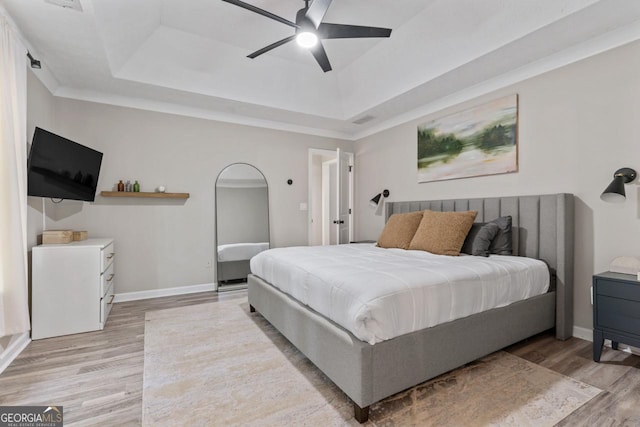 15 Stonewood Way, Sharpsburg, GA 30277 - bedroom featuring light wood-type flooring, a raised ceiling, and a ceiling fan