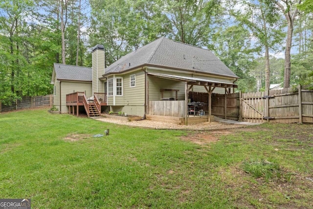 15 Stonewood Way, Sharpsburg, GA 30277 - rear view of house with a deck, a fenced backyard, a chimney, and a shingled roof
