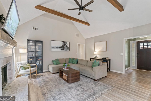 15 Stonewood Way, Sharpsburg, GA 30277 - living area featuring high vaulted ceiling, beam ceiling, wood finished floors, ceiling fan, and a brick fireplace