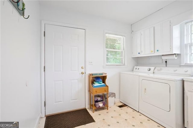 6381 Lakeview Dr, Buford, GA 30518 - washroom featuring washer and dryer, cabinet space, healthy amount of natural light, and light floors