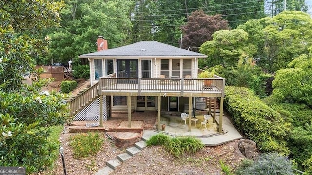 6381 Lakeview Dr, Buford, GA 30518 - back of house with stairs, a patio area, a deck, a chimney, and a sunroom