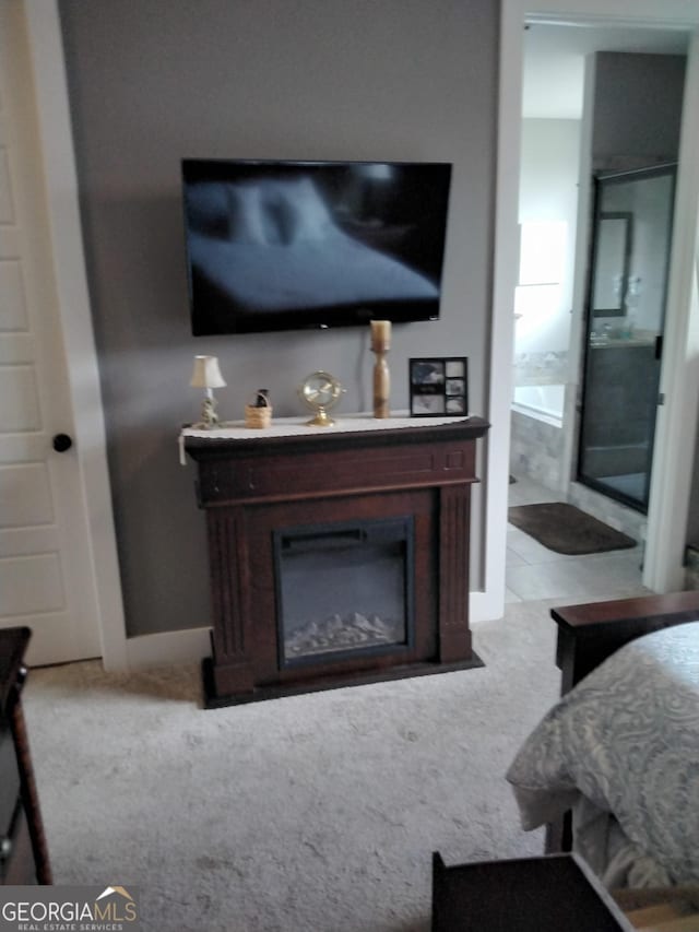 211 Barnyard Way, Perry, GA 31069 - bedroom featuring light colored carpet and a glass covered fireplace