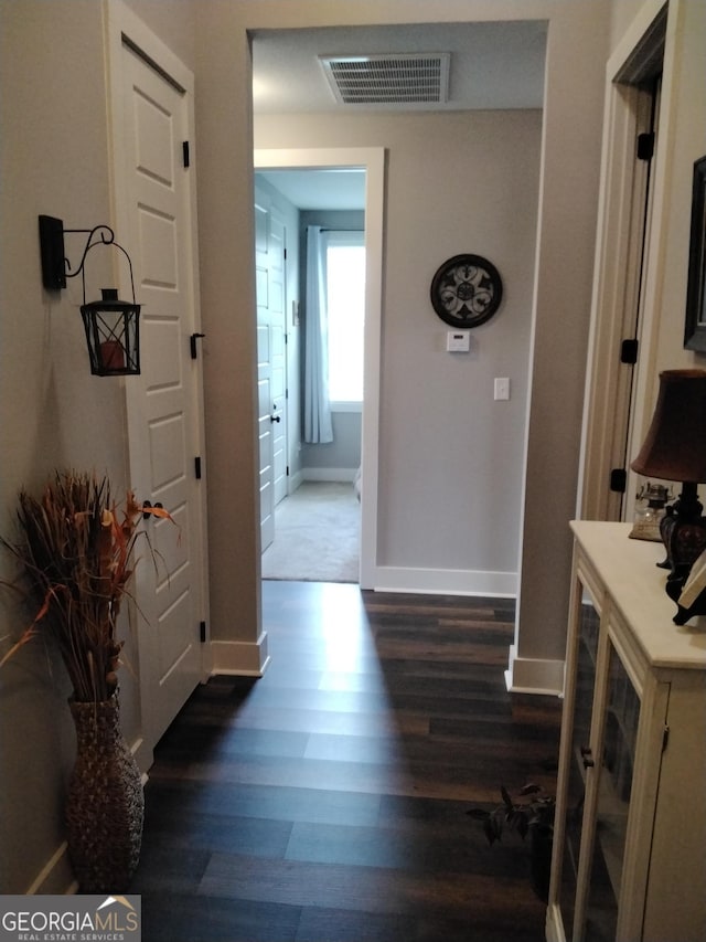 211 Barnyard Way, Perry, GA 31069 - hallway featuring dark wood-style floors and baseboards