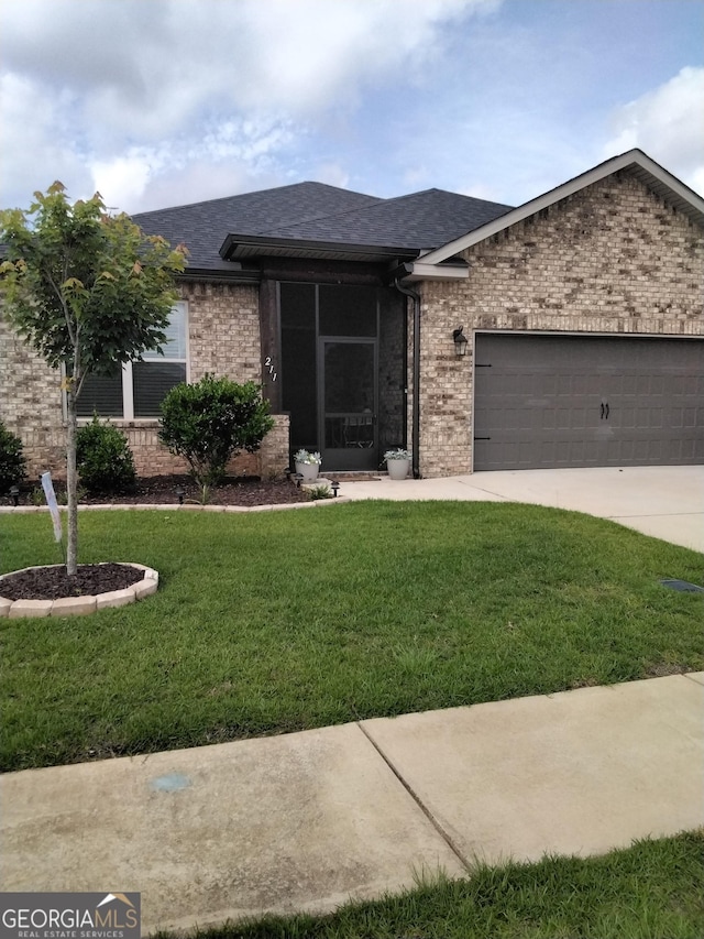 211 Barnyard Way, Perry, GA 31069 - ranch-style house with brick siding, an attached garage, a front lawn, and roof with shingles