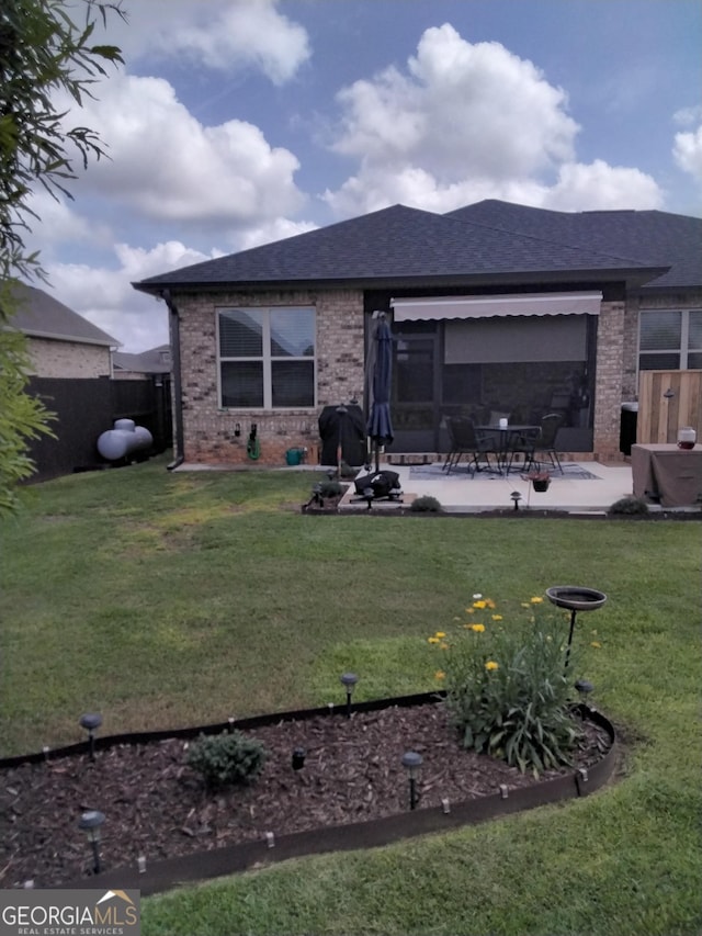 211 Barnyard Way, Perry, GA 31069 - back of property featuring brick siding, a patio, and a shingled roof