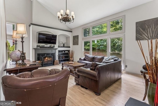 3835 Hickory Branch Trl, Suwanee, GA 30024 - living room featuring light wood-style flooring, a premium fireplace, a chandelier, and high vaulted ceiling