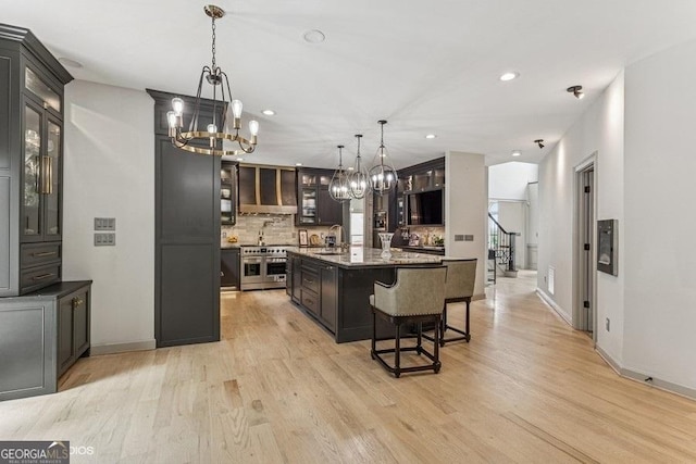 3835 Hickory Branch Trl, Suwanee, GA 30024 - kitchen with a chandelier, range with two ovens, light wood-type flooring, a large island, and recessed lighting