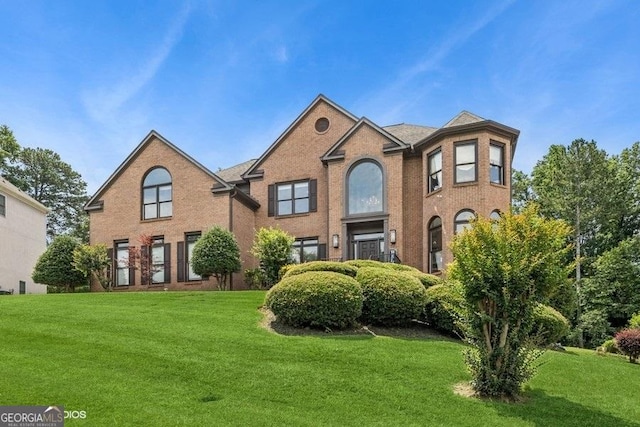 3835 Hickory Branch Trl, Suwanee, GA 30024 - view of front facade with a front yard and brick siding