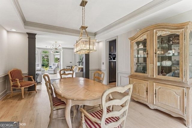 3835 Hickory Branch Trl, Suwanee, GA 30024 - dining area with ornamental molding, a wainscoted wall, light wood finished floors, a decorative wall, and a chandelier