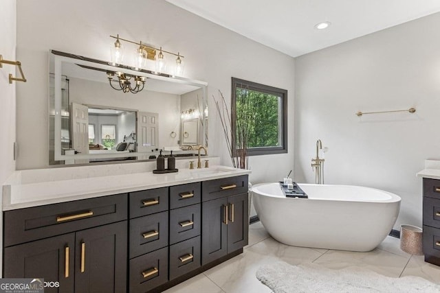 3835 Hickory Branch Trl, Suwanee, GA 30024 - full bathroom with vanity, a freestanding tub, and a chandelier