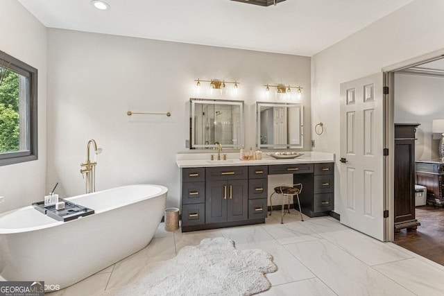 3835 Hickory Branch Trl, Suwanee, GA 30024 - full bath featuring double vanity, a freestanding tub, and marble finish flooring