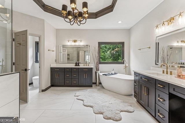 3835 Hickory Branch Trl, Suwanee, GA 30024 - bathroom featuring two vanities, a raised ceiling, a freestanding tub, a chandelier, and crown molding