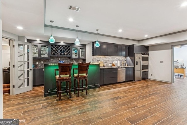 3835 Hickory Branch Trl, Suwanee, GA 30024 - indoor bar featuring tasteful backsplash, appliances with stainless steel finishes, dark wood-style flooring, decorative light fixtures, and recessed lighting