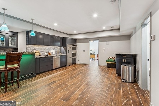 3835 Hickory Branch Trl, Suwanee, GA 30024 - kitchen featuring tasteful backsplash, dark wood-style floors, stainless steel dishwasher, hanging light fixtures, and a raised ceiling