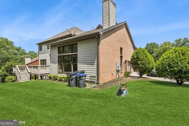 3835 Hickory Branch Trl, Suwanee, GA 30024 - back of property with a wooden deck, a chimney, a yard, and brick siding