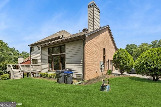 3835 Hickory Branch Trl, Suwanee, GA 30024 - back of property featuring a wooden deck, a chimney, brick siding, and a yard