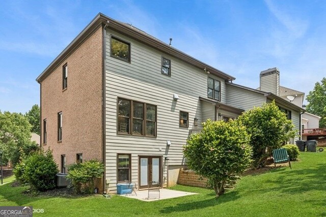 3835 Hickory Branch Trl, Suwanee, GA 30024 - back of house featuring a lawn, a chimney, and a patio