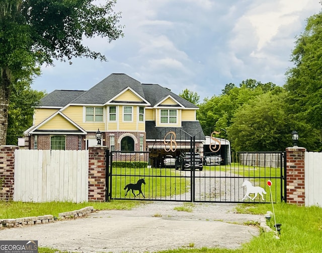2481 Islands Hwy, Midway, GA 31320 - view of front of property with a fenced front yard, a gate, brick siding, and roof with shingles