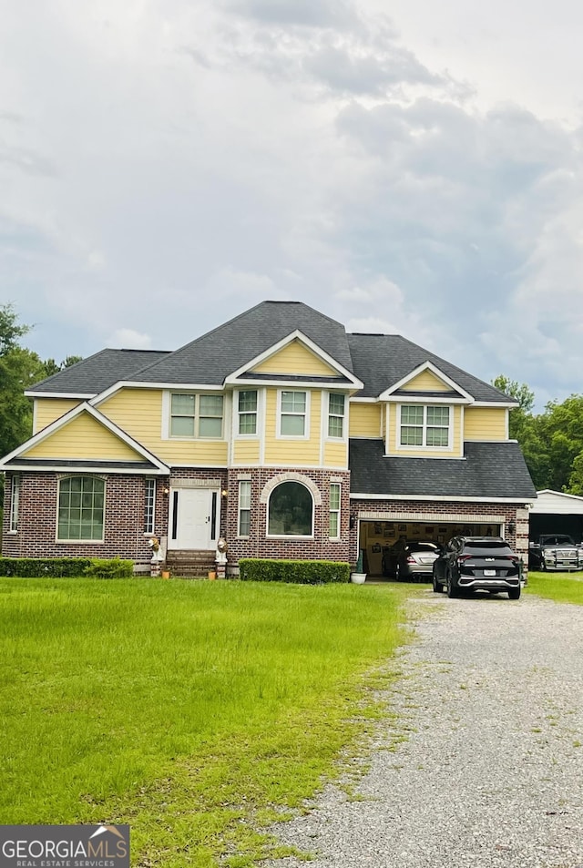 2481 Islands Hwy, Midway, GA 31320 - view of front of home featuring gravel driveway, roof with shingles, and brick siding