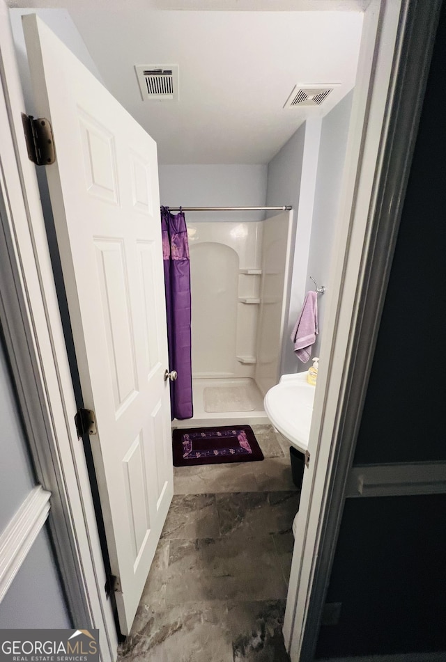 2481 Islands Hwy, Midway, GA 31320 - bathroom featuring a shower with shower curtain and a sink
