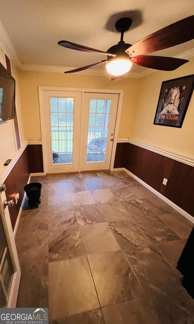 2481 Islands Hwy, Midway, GA 31320 - doorway to outside with ornamental molding, wainscoting, a ceiling fan, and wooden walls