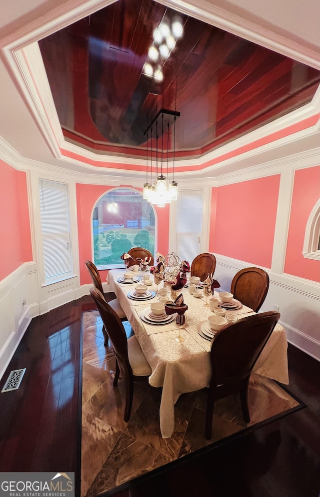 2481 Islands Hwy, Midway, GA 31320 - dining space with a tray ceiling, ornamental molding, a decorative wall, a wainscoted wall, and a chandelier