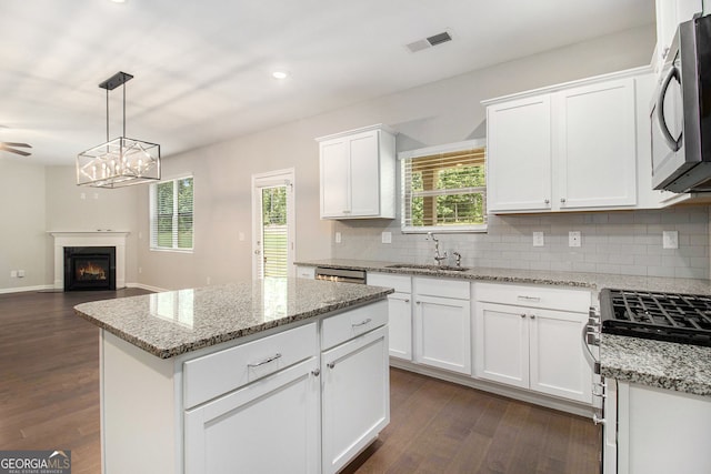 8041 Louis Dr, Locust Grove, GA 30248 - kitchen with stainless steel appliances, backsplash, dark wood-type flooring, white cabinets, and recessed lighting
