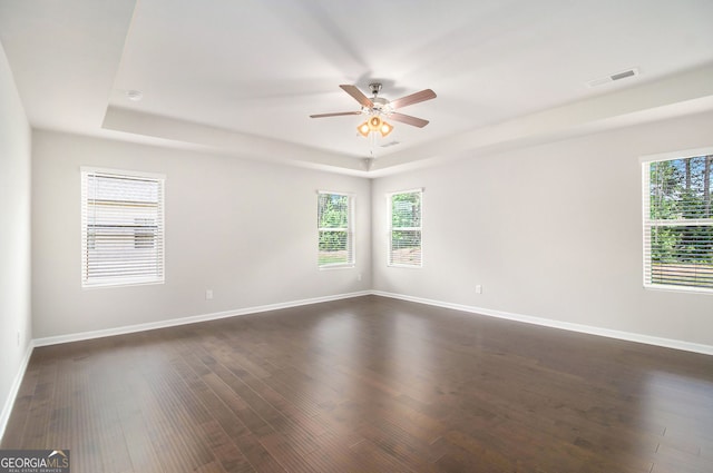 8041 Louis Dr, Locust Grove, GA 30248 - empty room featuring a tray ceiling, ceiling fan, and plenty of natural light