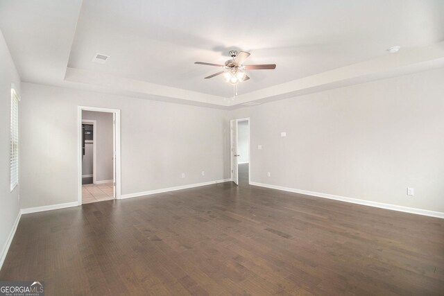 8041 Louis Dr, Locust Grove, GA 30248 - unfurnished room featuring a raised ceiling, a ceiling fan, and wood finished floors