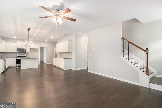 8041 Louis Dr, Locust Grove, GA 30248 - unfurnished living room featuring a ceiling fan, dark wood-type flooring, recessed lighting, and stairs