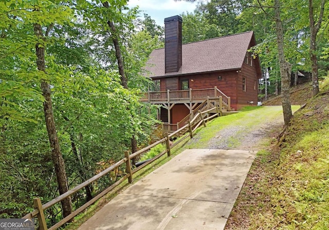 73 Rosiey Ln Unit 356, Blue Ridge, GA 30513 - view of home's exterior with a wooden deck, a chimney, stairs, a shingled roof, and driveway